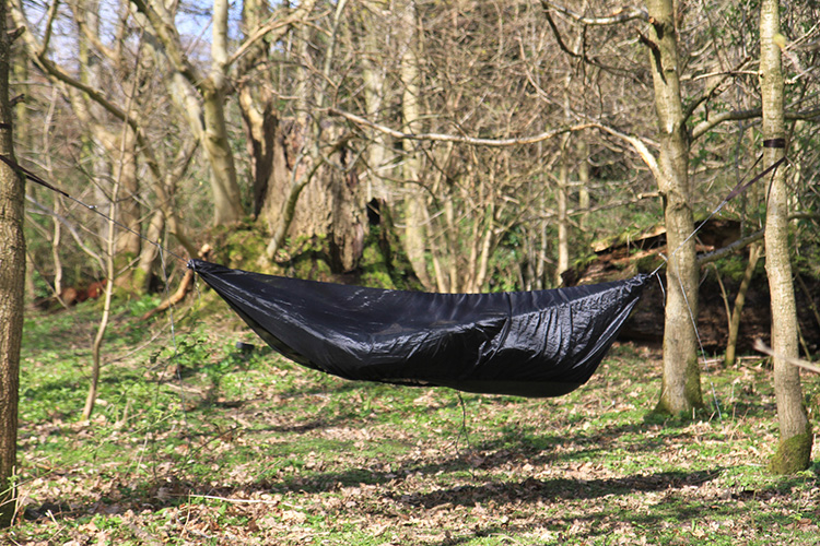 DD Superlight mosquito net used with green Superlight hammock in the woods